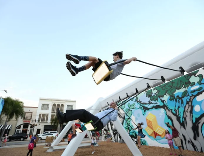 Try out the Musical Swings Public Art Installation on lawn of the Williamsburg Community Building