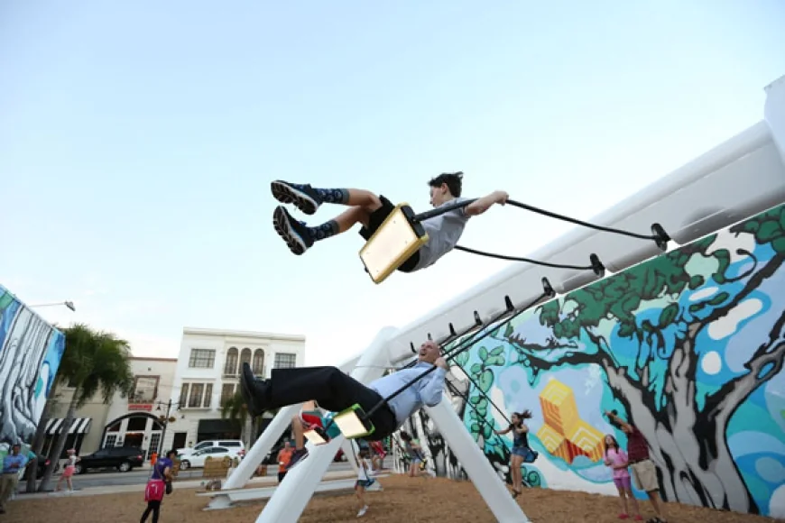 Try out the Musical Swings Public Art Installation on lawn of the Williamsburg Community Building